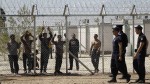 Police officers patrol a detention centre for immigrants in the Amygdaleza suburb in Athens